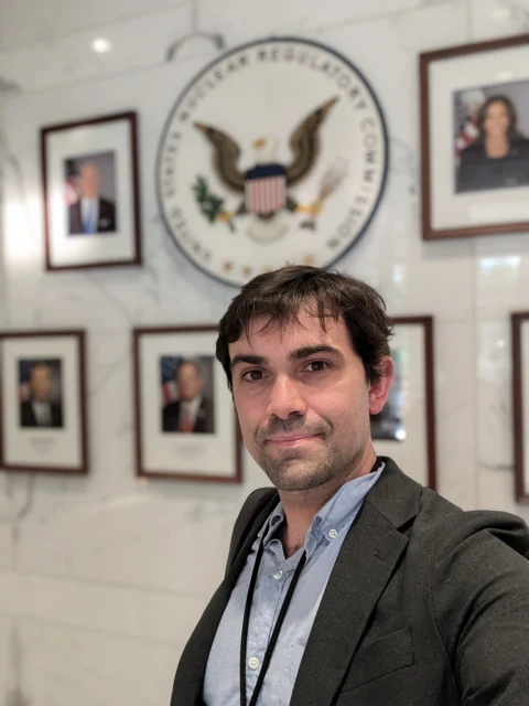 Ryan standing in front of the U.S. Nuclear Regulatory Commission seal.