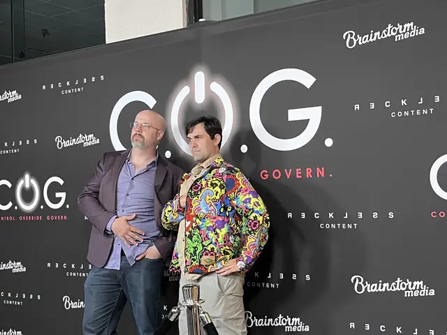 Two people at a C.O.G. film event; Ryan wears a brightly patterned jacket.